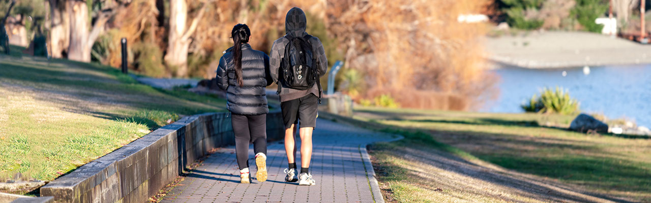 young couple walking on a path