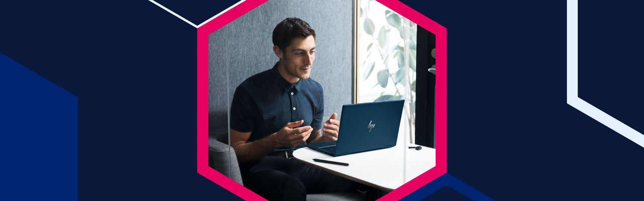 Man sitting at a table on a video call using an HP laptop