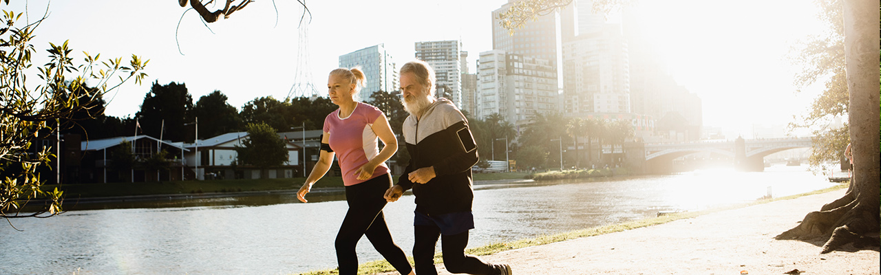 couple jogging along the banks of a rive in Melbourne