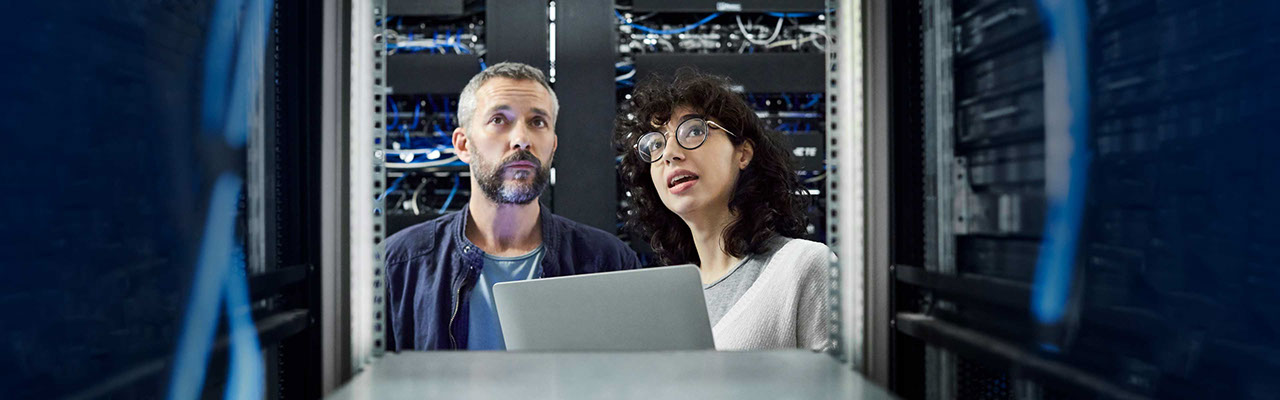 A man and a woman discussing rack space sizing in a data centre