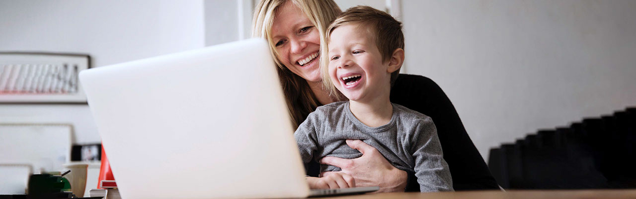 Mother and her child using a laptop together