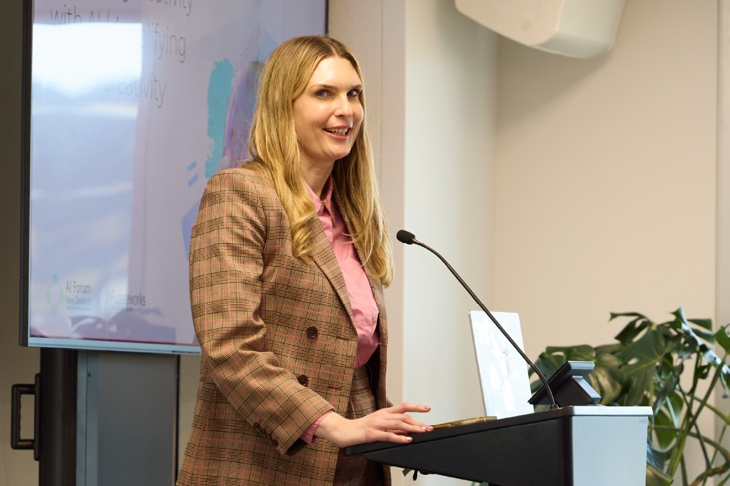Lady at a lectern addressing the audience