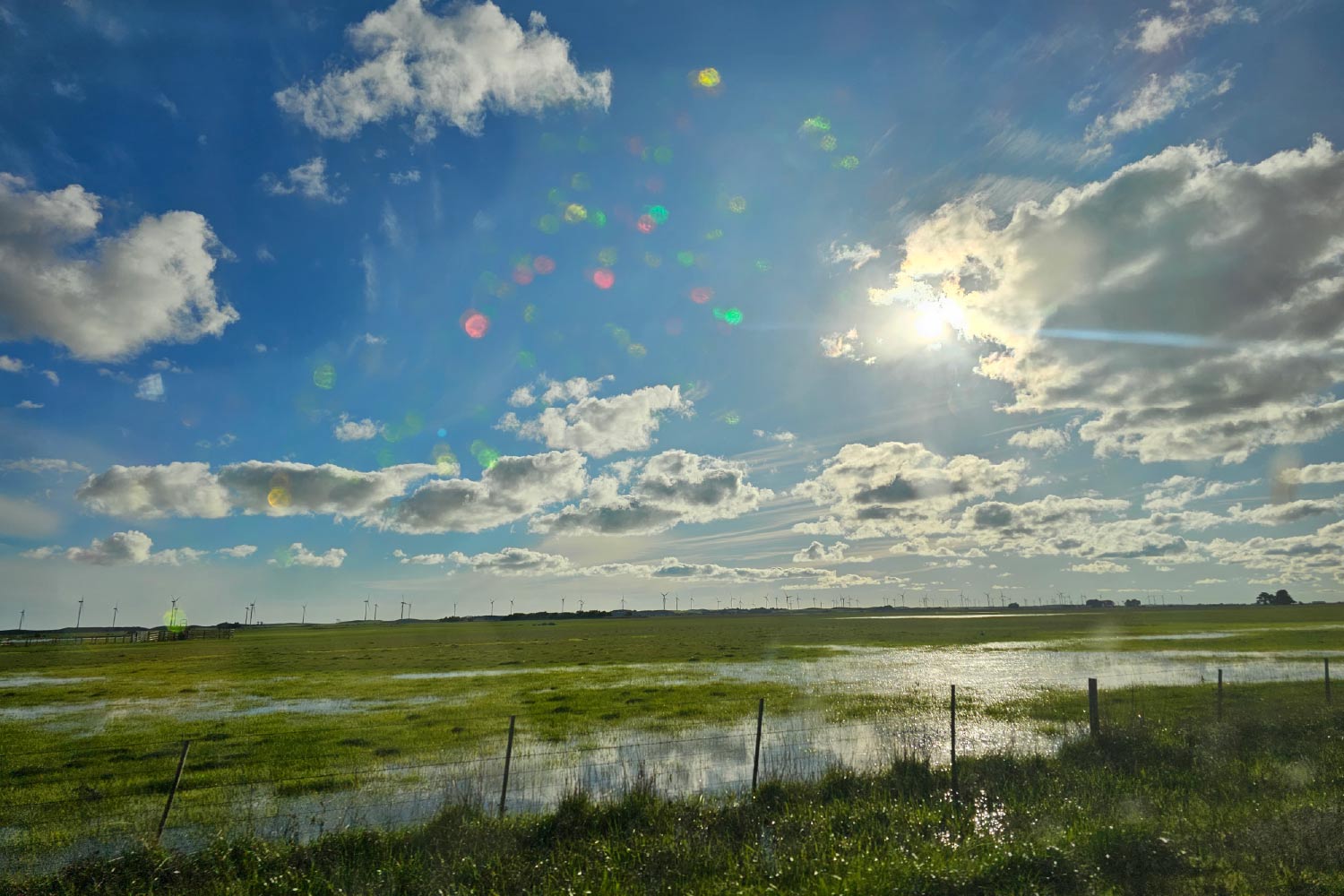 Scenic image of a field and a blue sky with clouds