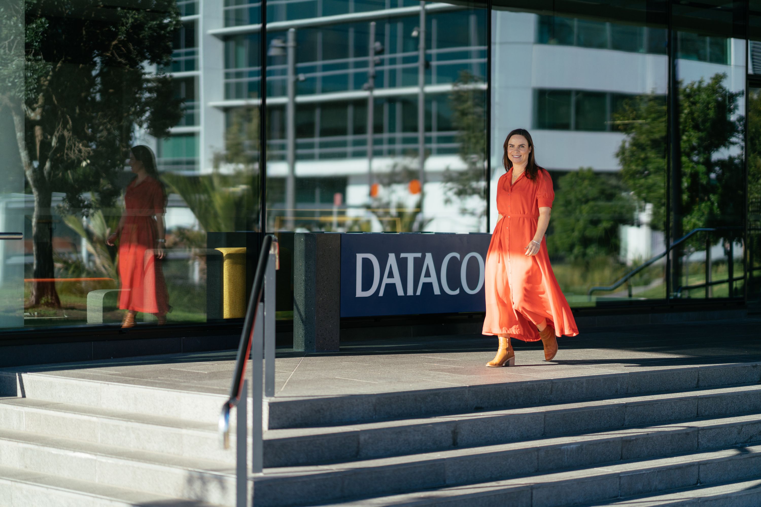 Kaye Harding full body walking shot in front of Datacom Auckland office