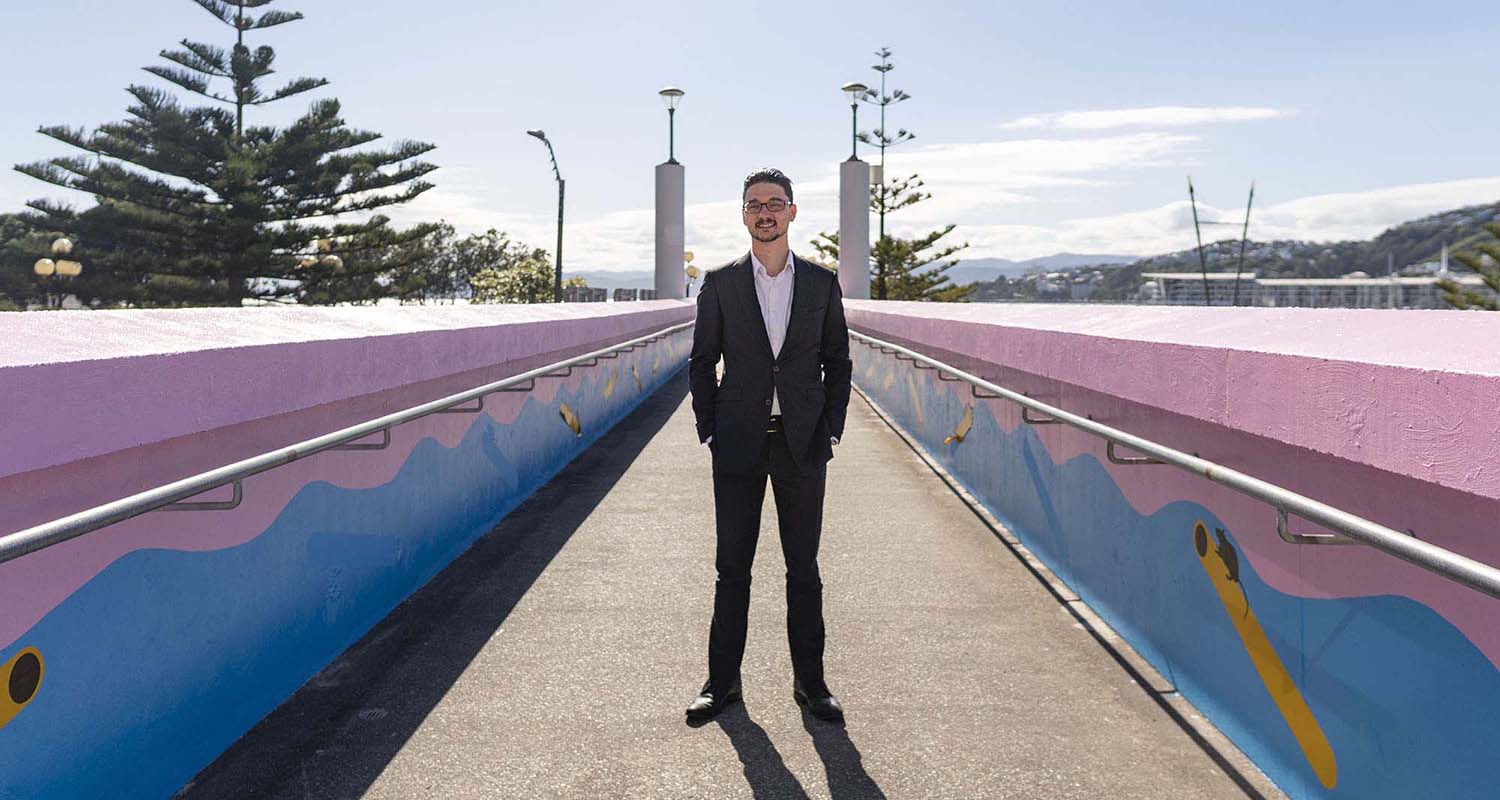 Wide-shot of Nick Wilkinson standing in the middle of a walkway