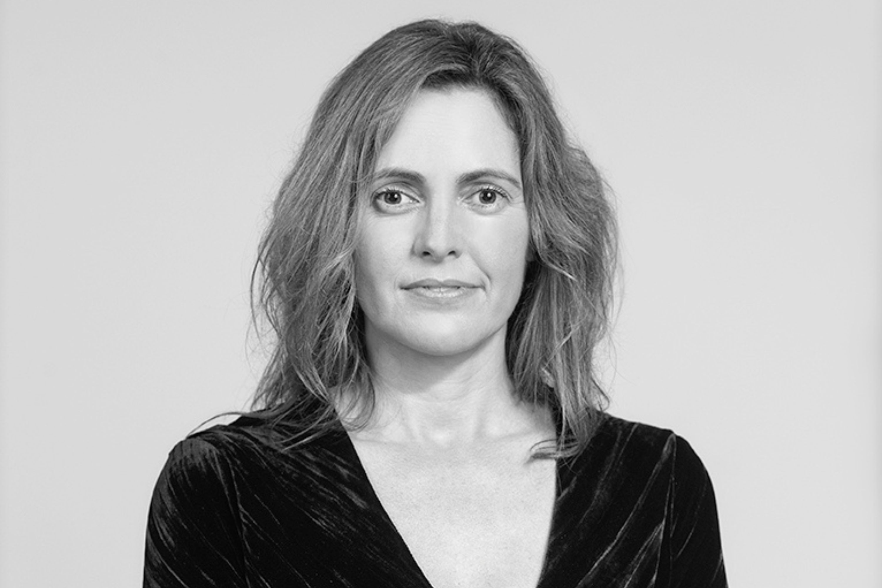 A black and white profile photo of Tracey Cotter-Martin looking into the camera