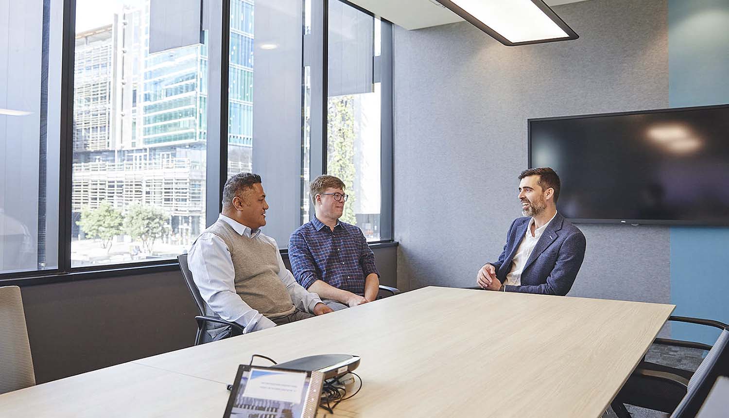 Russell Page-Wood having a discussion with clients at Datacom's Auckland office