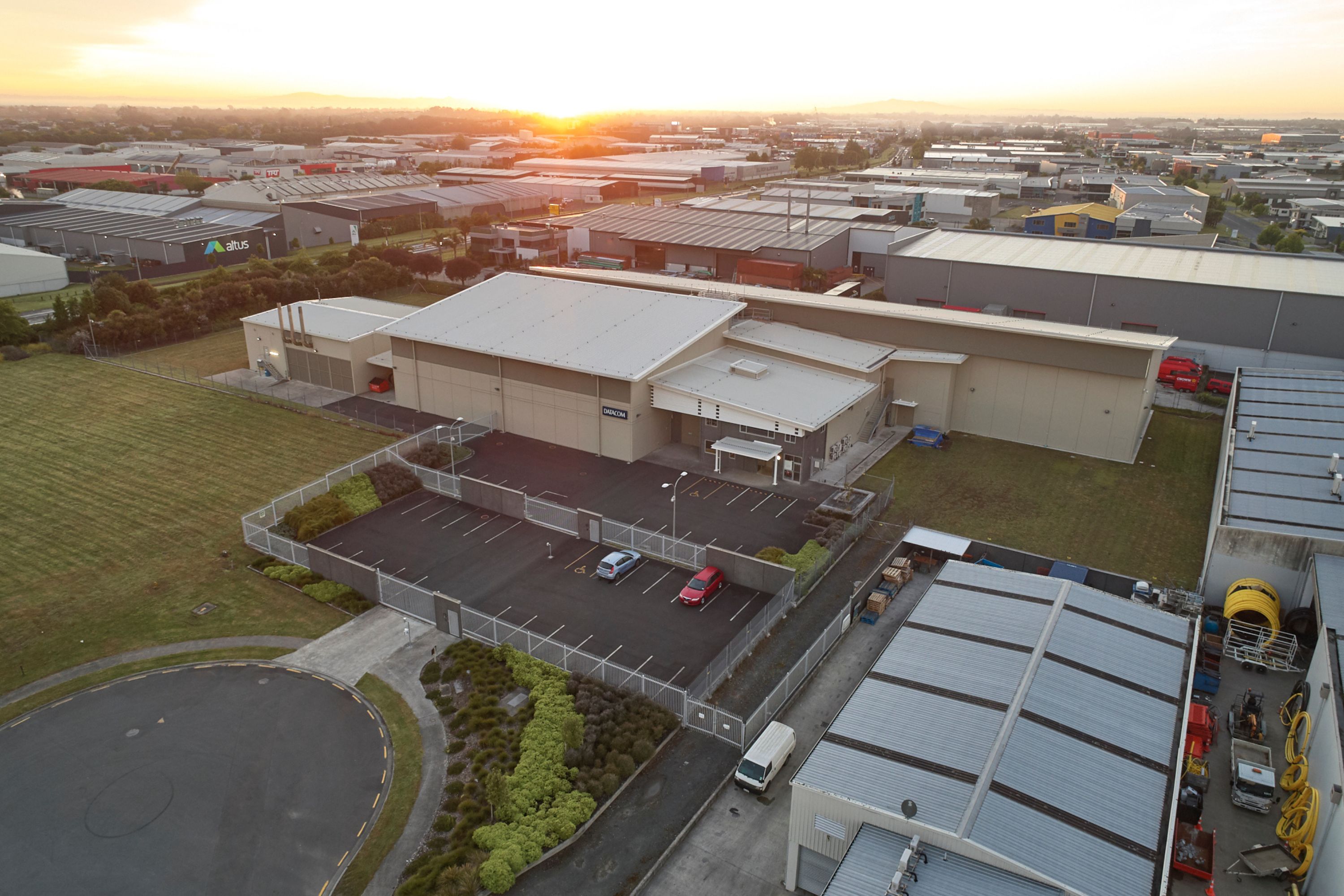 Aerial view of the Datacom Hamilton Kapua data centre at sunset on a clear evening