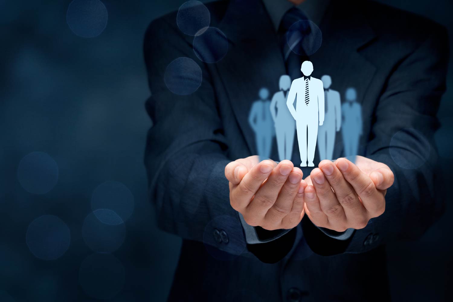 Businessman in a suit holding holographic icons of people