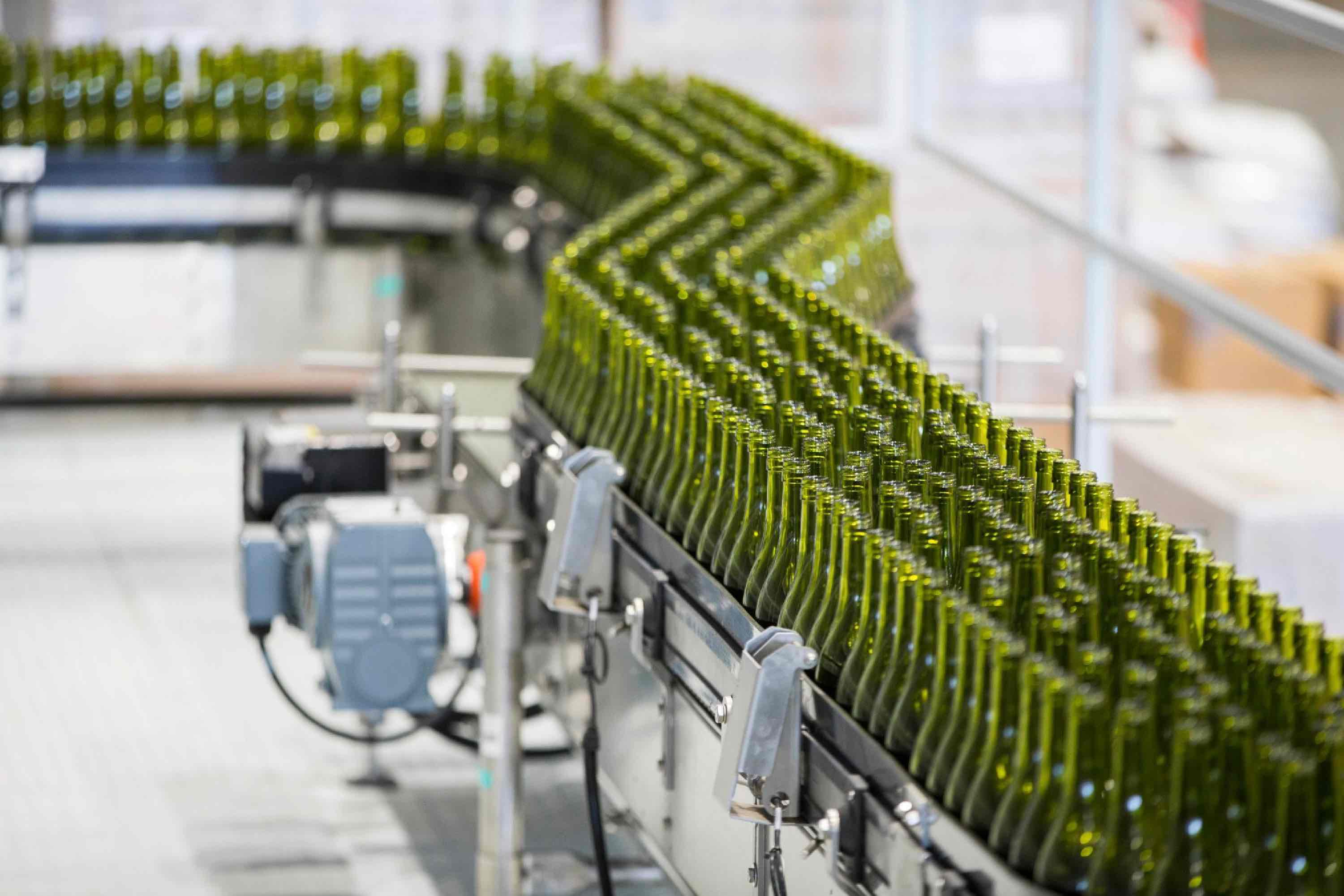 Wine bottles on a getting processed