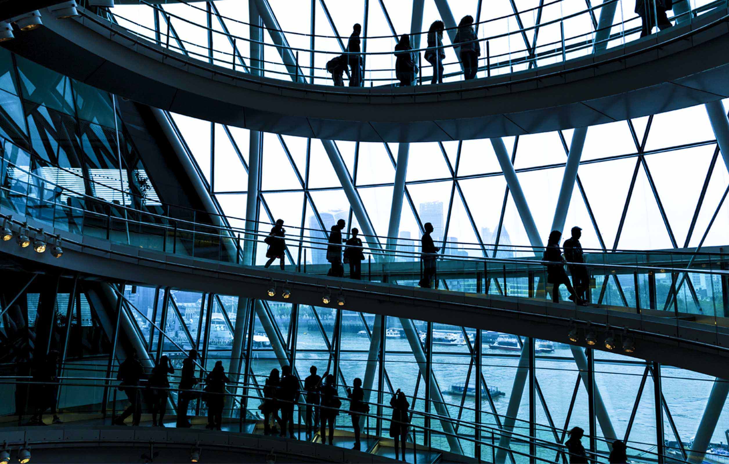 A wide shot of the interior architecture of a corporate building with people walking