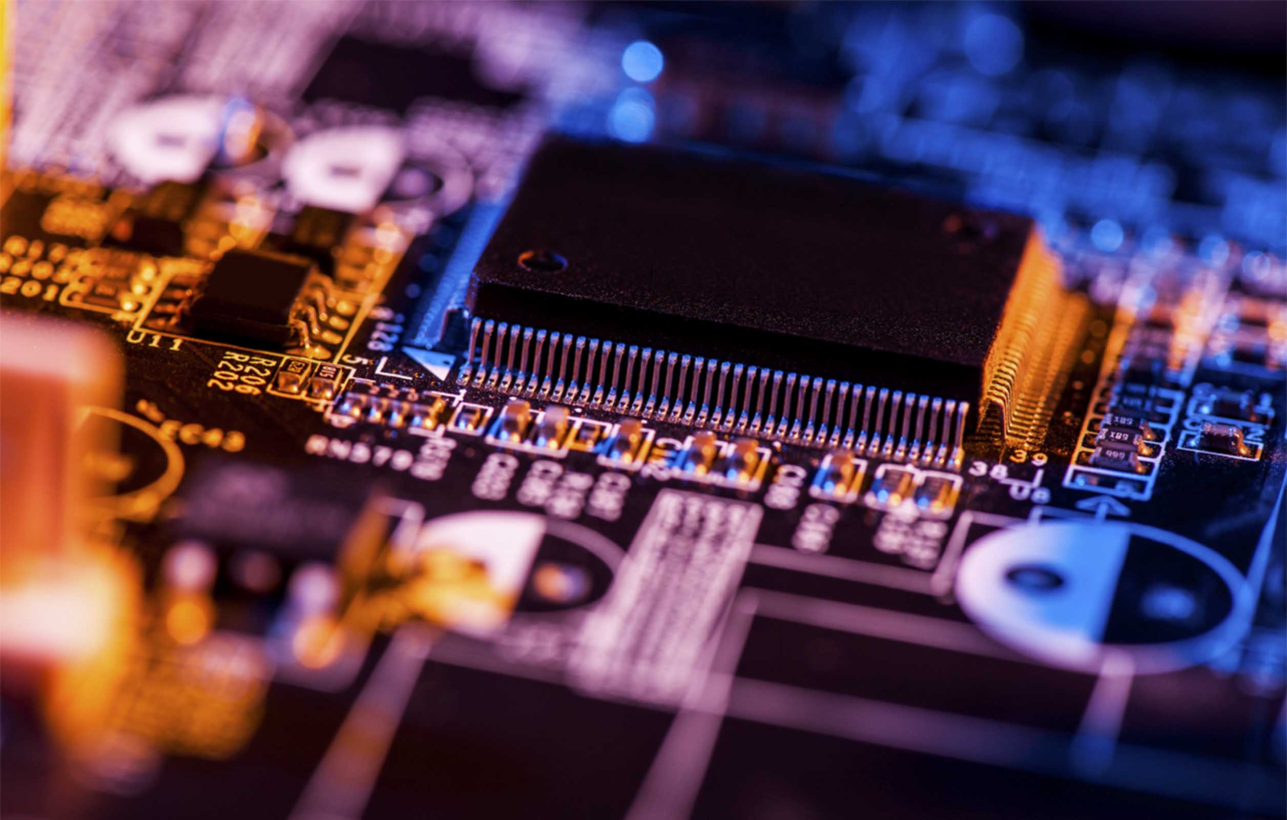 A close up shot of a circuit board with a large processing chip
