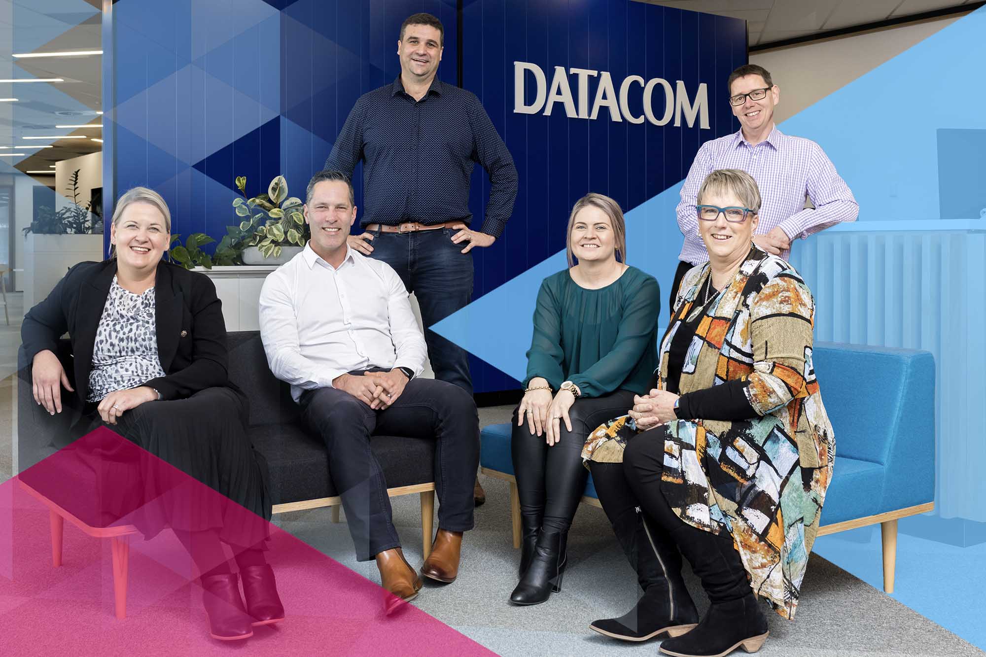 Smiling Datacom people in the Hamilton office