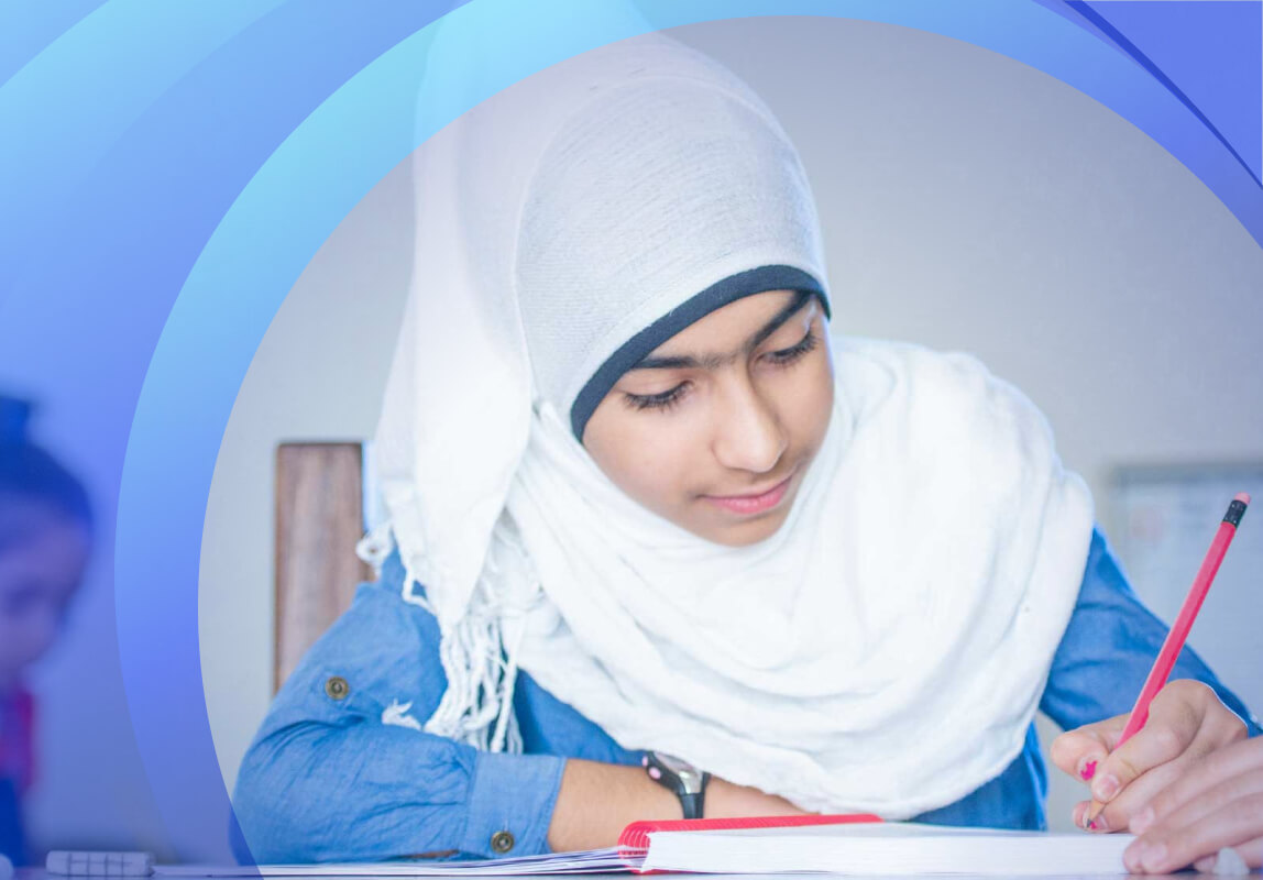 Girl wearing hijab writing