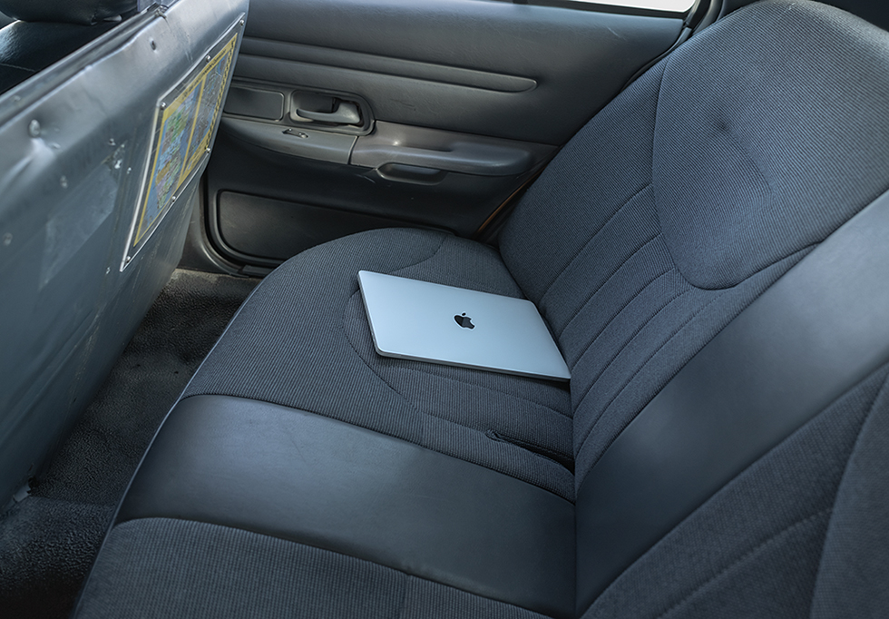 Apple laptop on a car seat