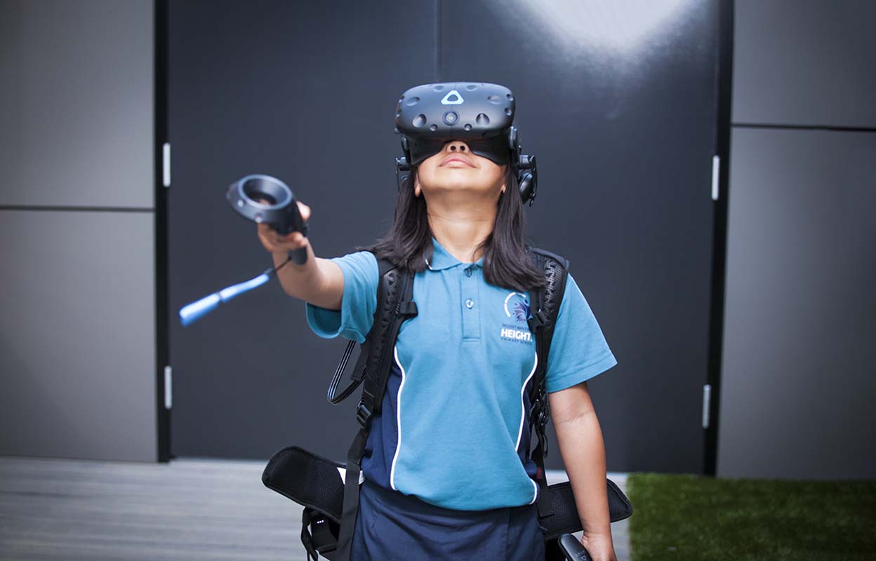 A child using a VR heaset and gesture remote