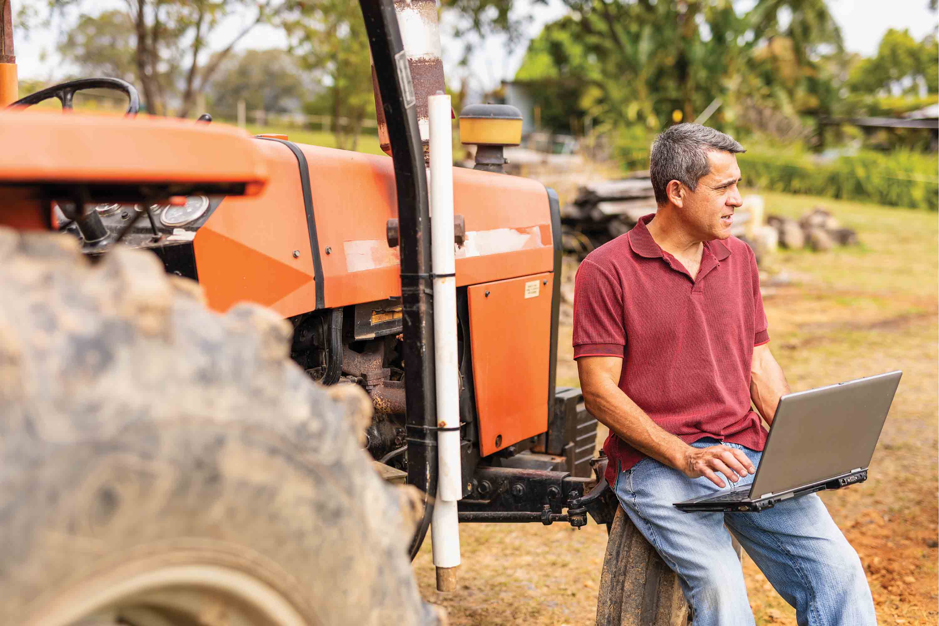 Man with laptop on tractor