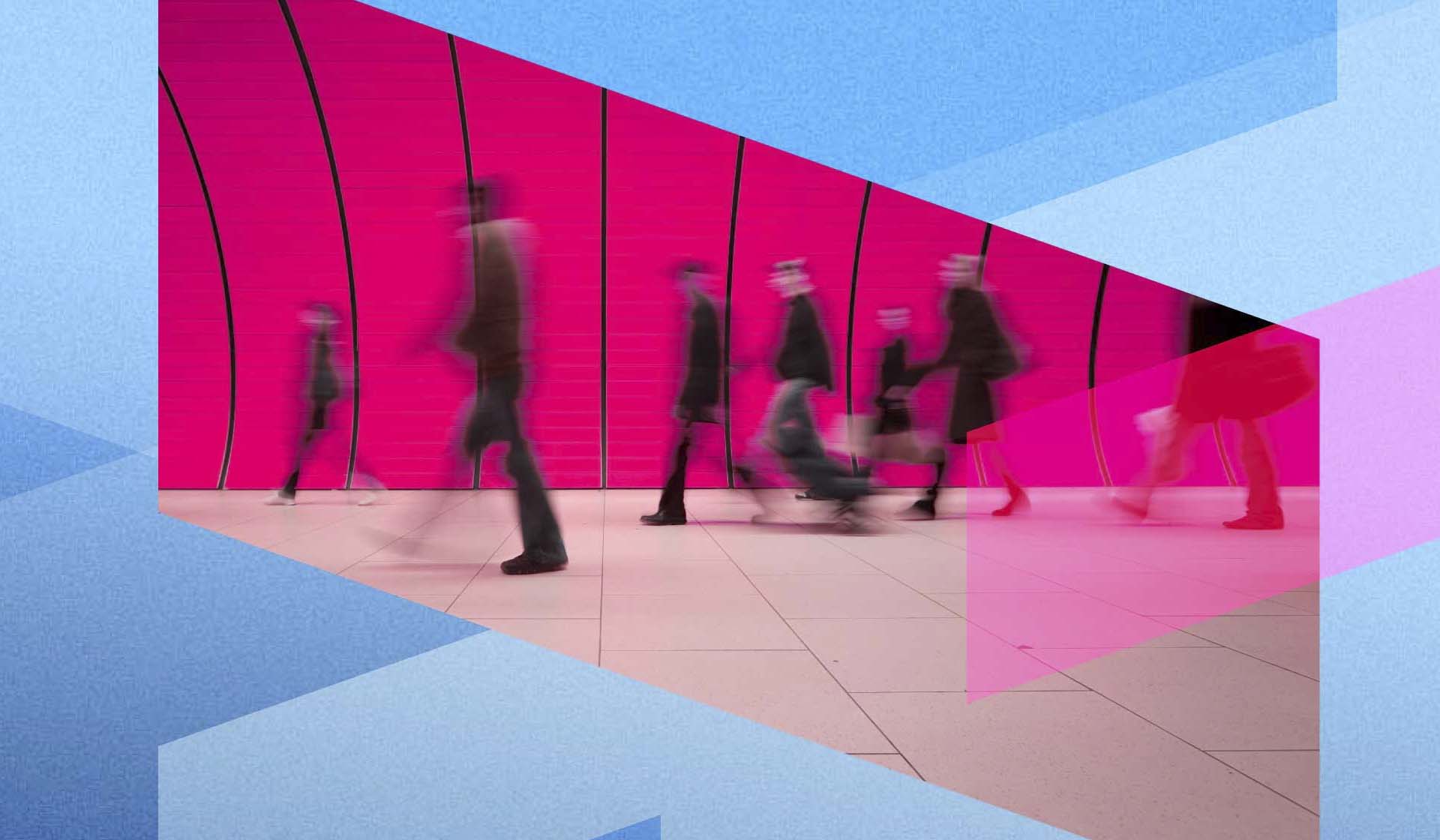 A long exposure shot of people walking through a pink tunnel