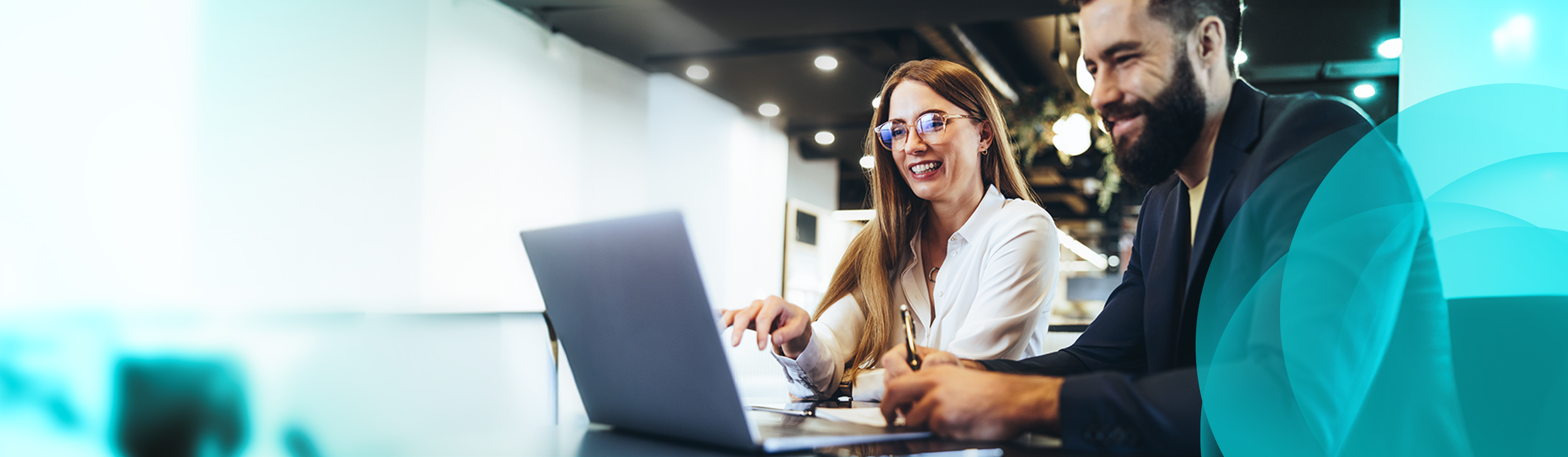 Two smiling people discussing payroll products