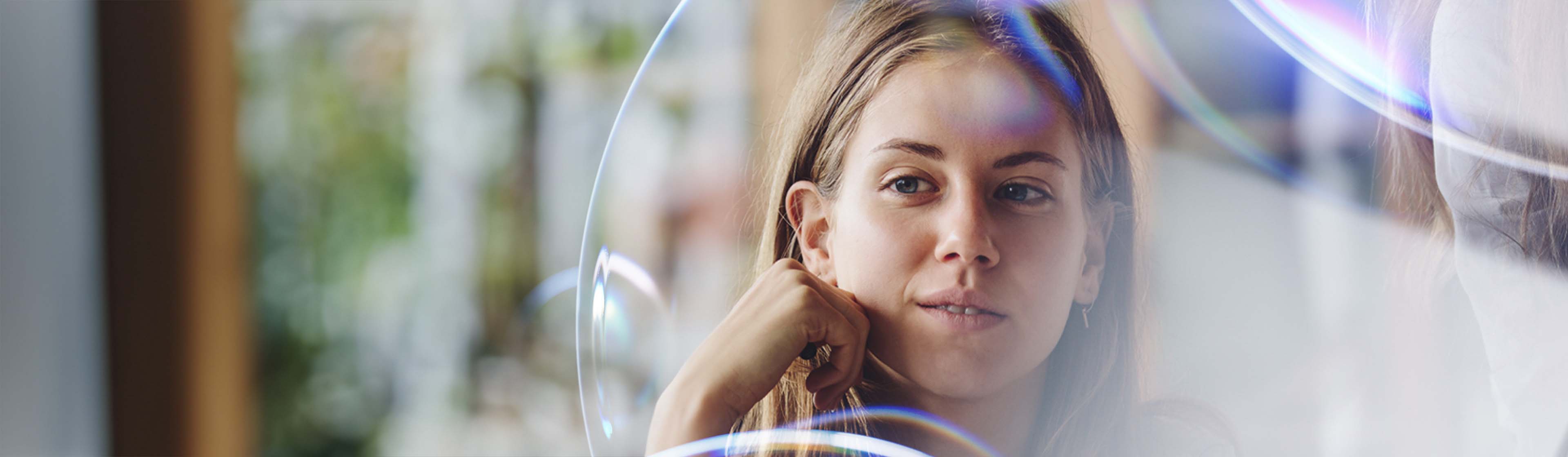 A young woman in thought viewed through the Datacom lens