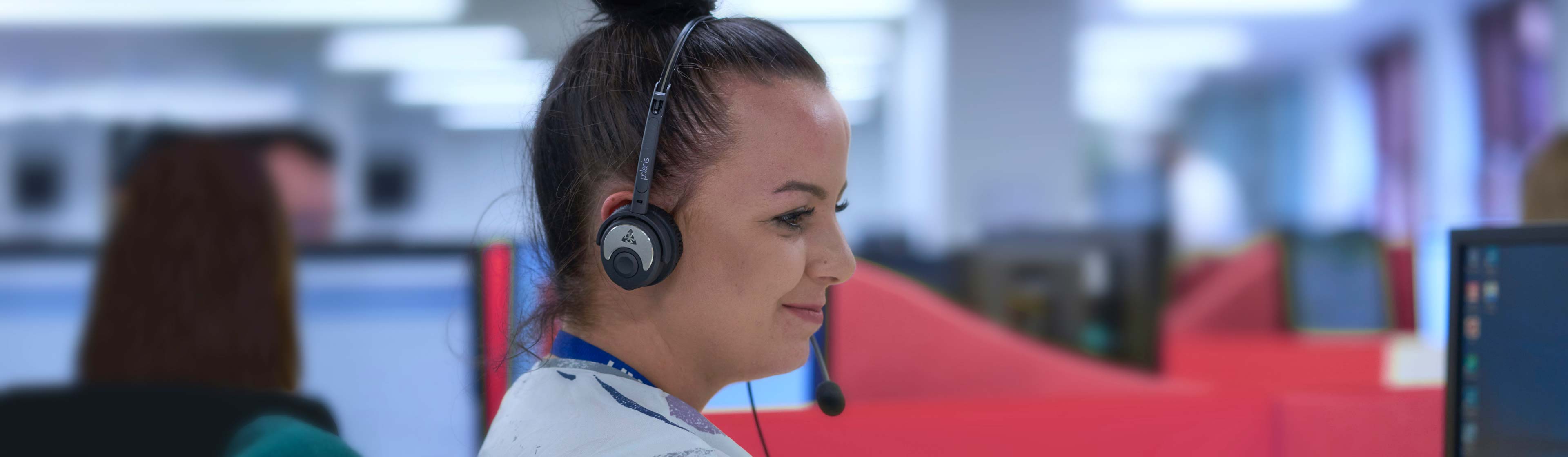 A female contact centre worker on a customer call