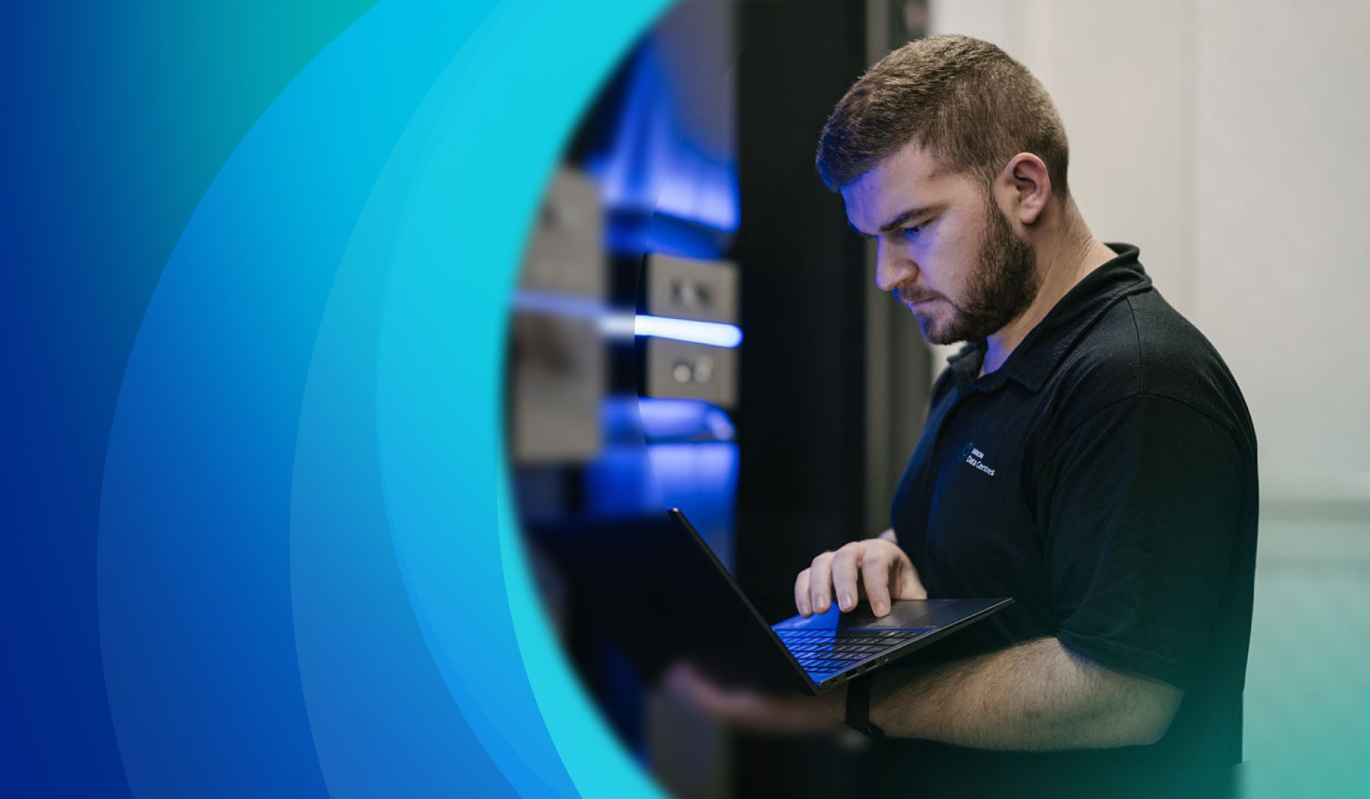Man in data centre next to data centre racks
