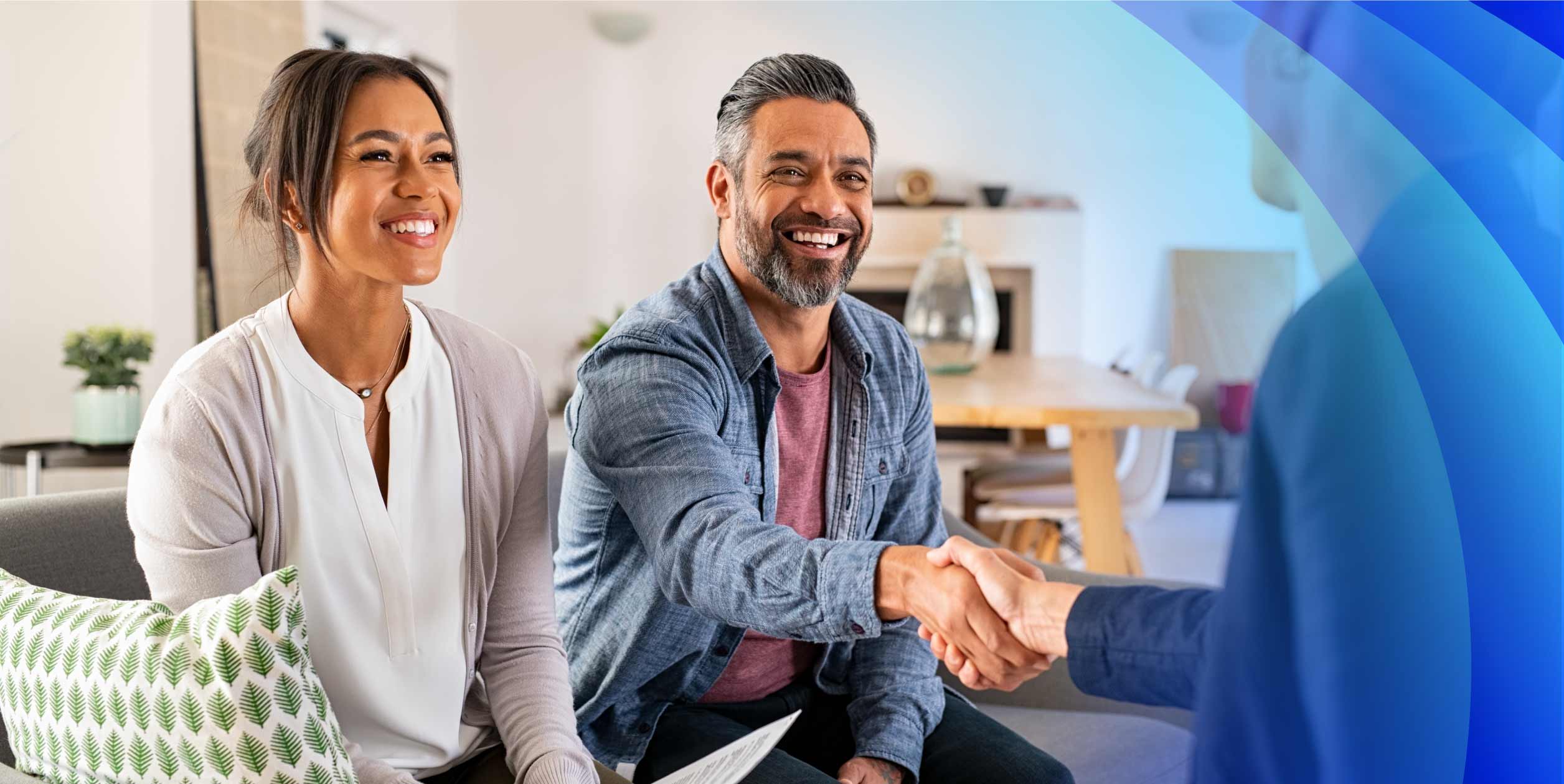 Two customers talking and shaking hands with a CX specialist
