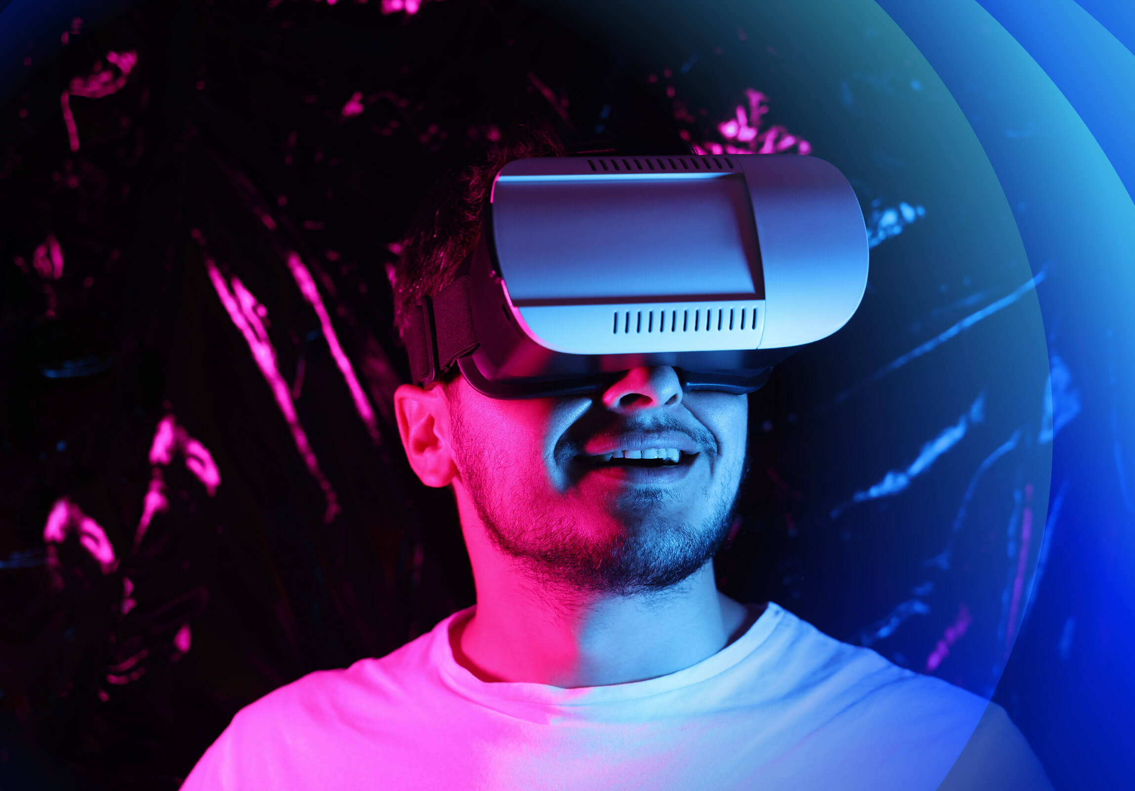 A man wearing VR Glasses and smiling