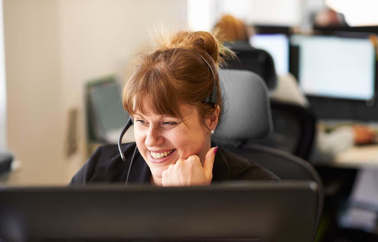 A female contact centre operator talking in a headset