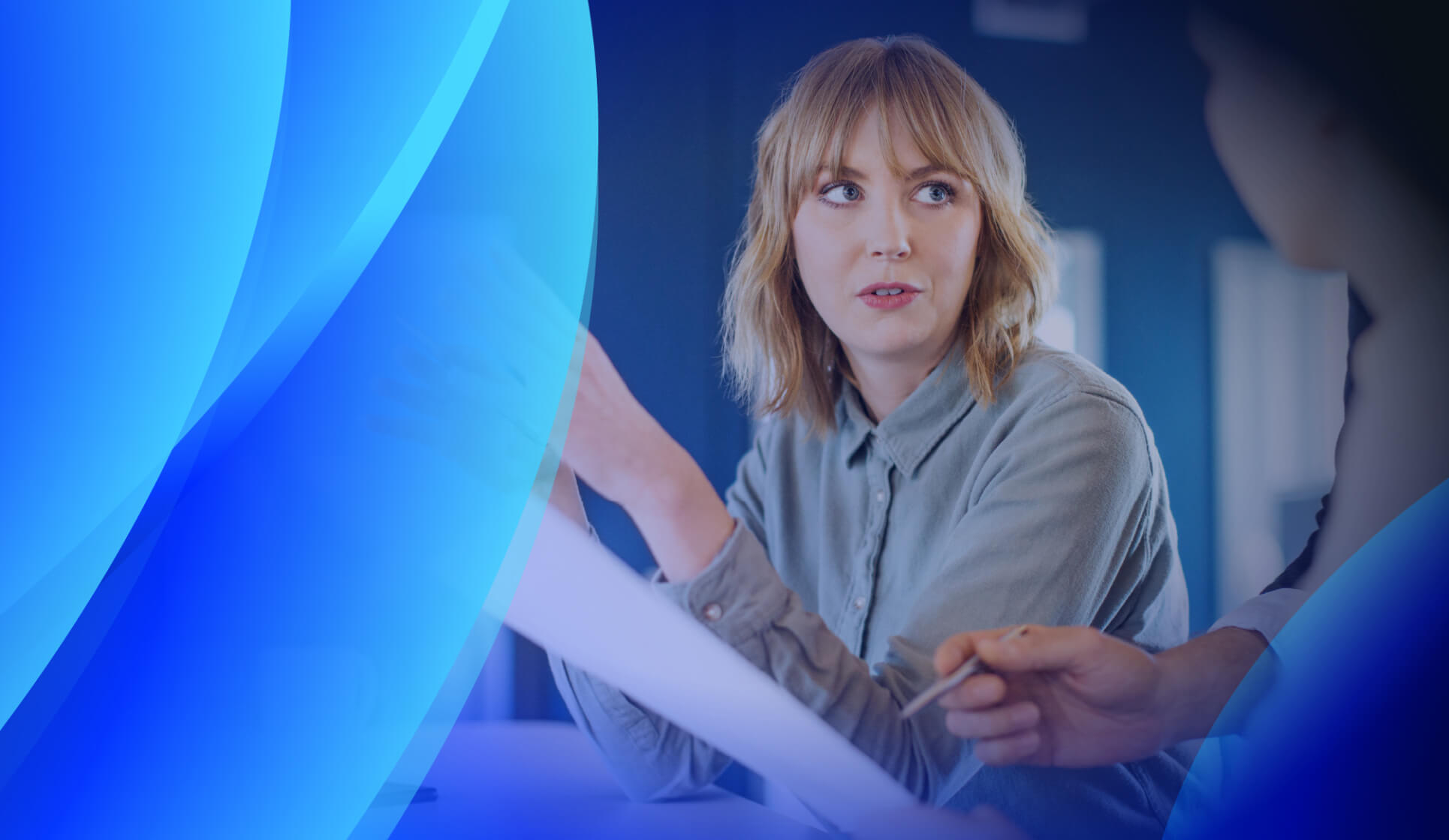 Two people discussing software asset management documents during a meeting