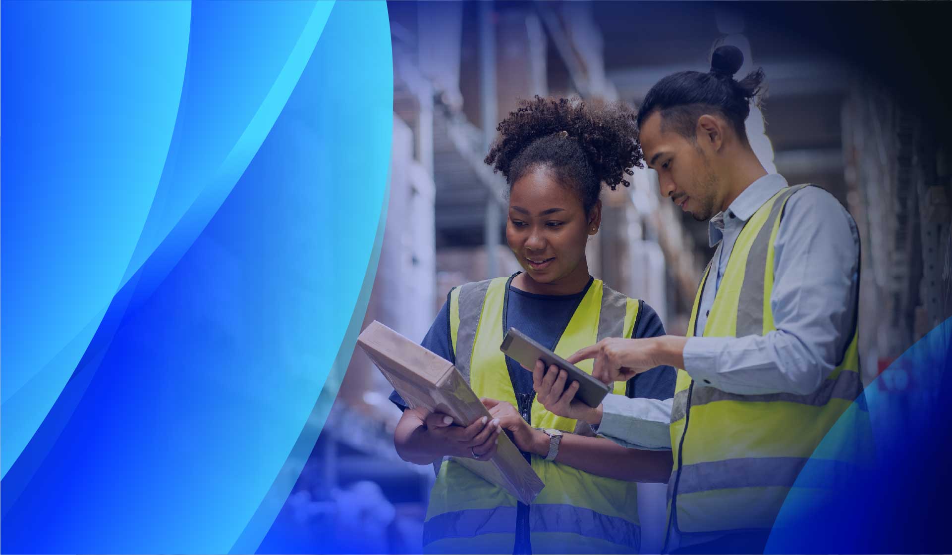 Two workers reviewing software licensing on a tablet in a warehouse