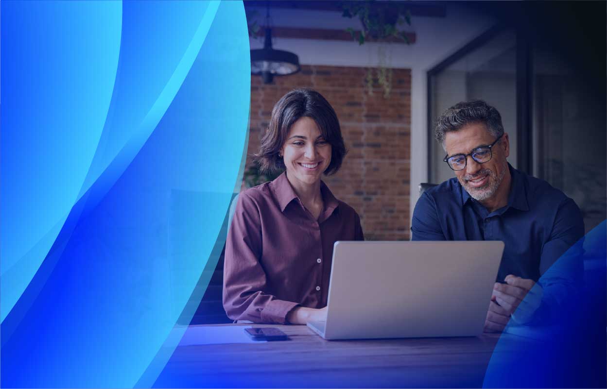 A man and woman reviewing their software licensing on a laptop