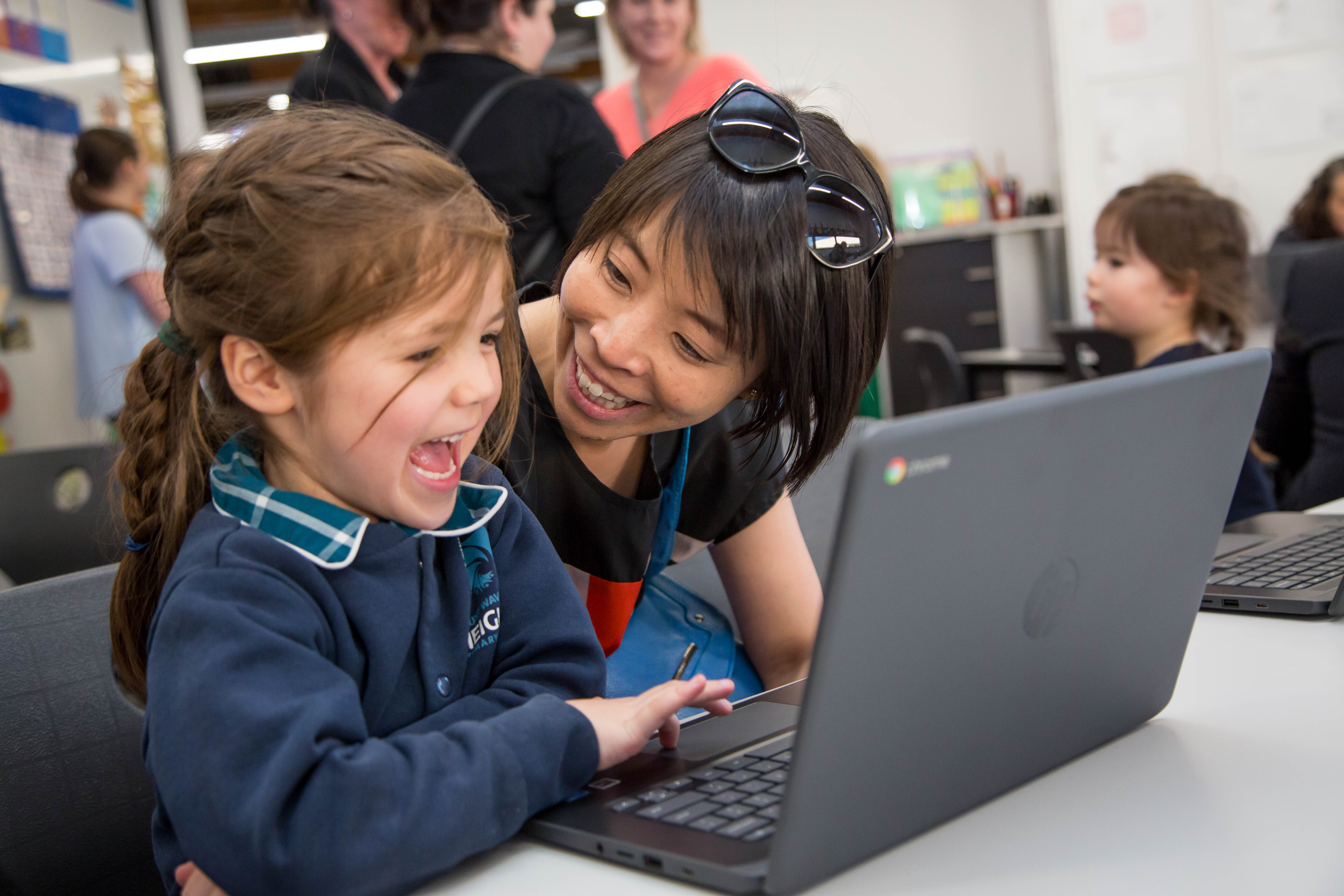 Schoolchildren using a laptop