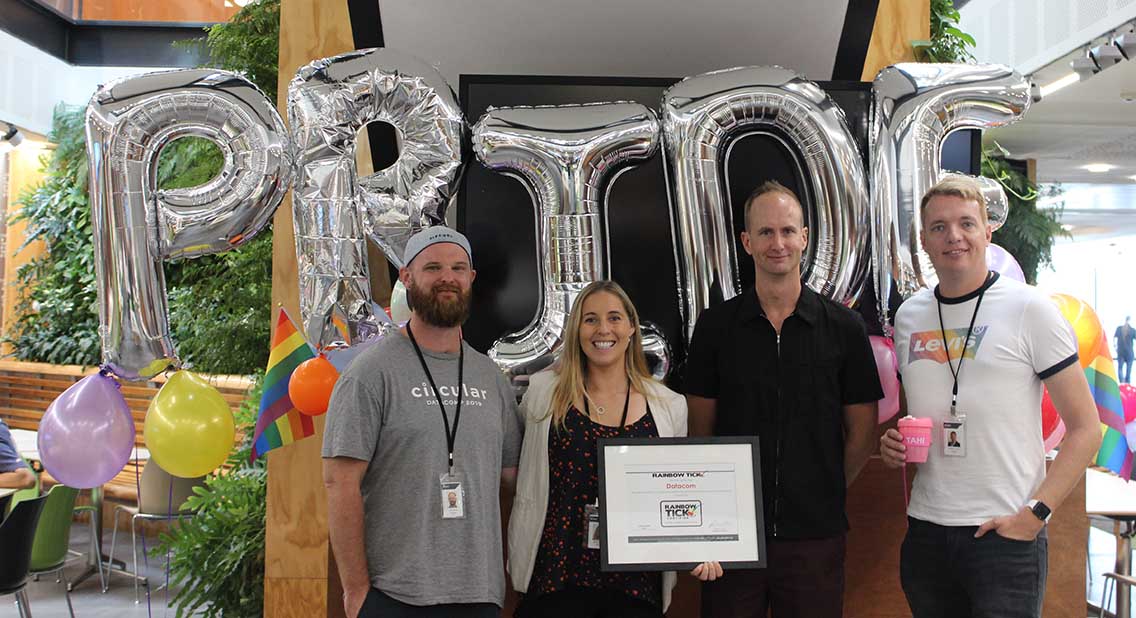 Datacom employees celebrate being awarded the Rainbow Tick