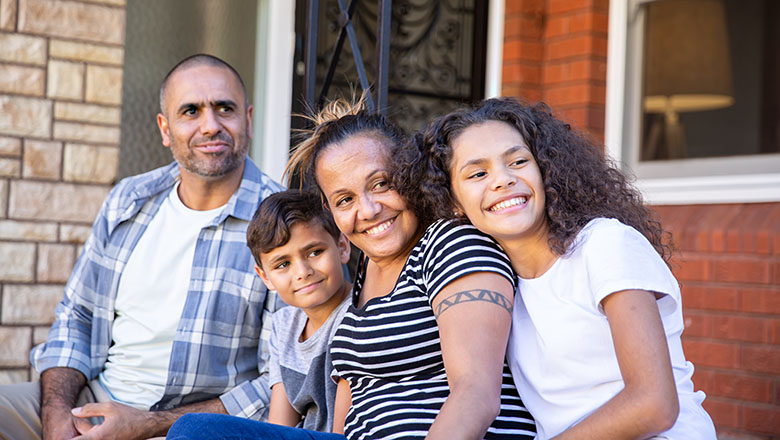 Australian family sitting on their front porch