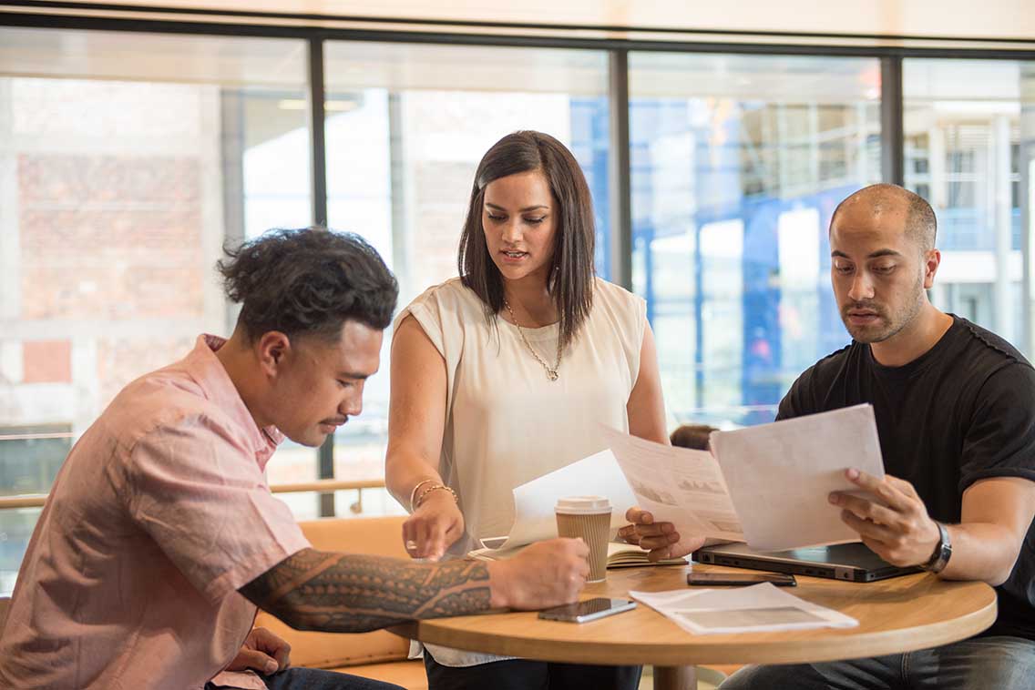 three people working at a table