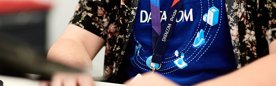 Partial image of someone typing, wearing Datacom ID tags.