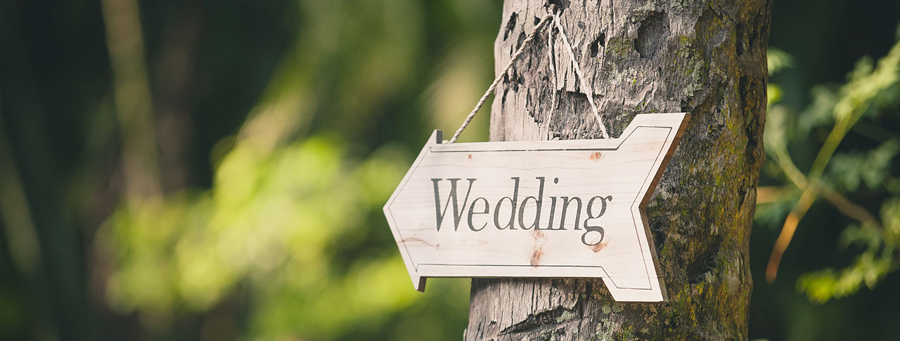 signage pointing to a wedding