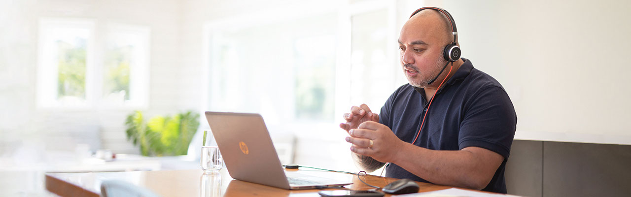 A man attends a virtual conference call at home