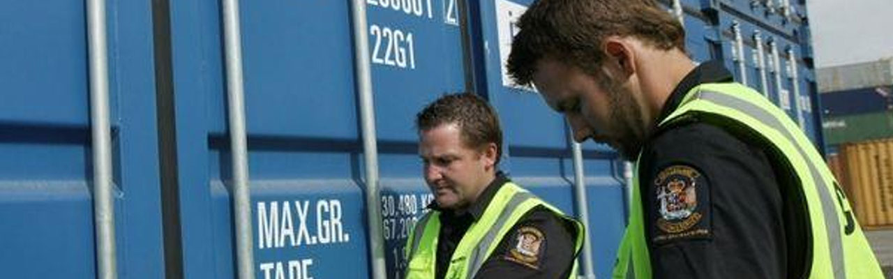 customs officials opening a container