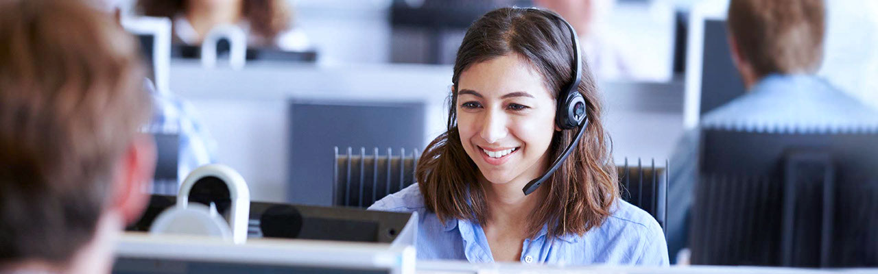A smiling customer service representative on a call