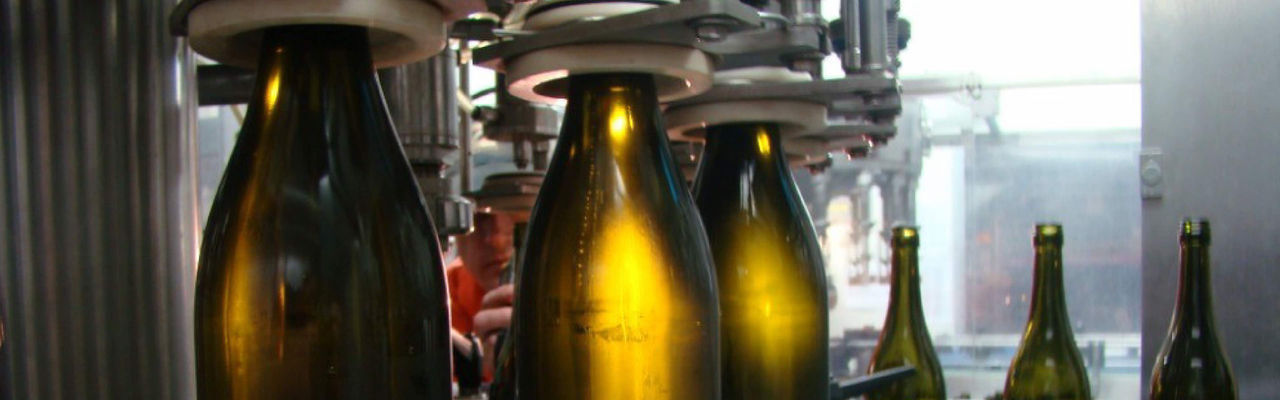 Wine bottles being processed by a machine