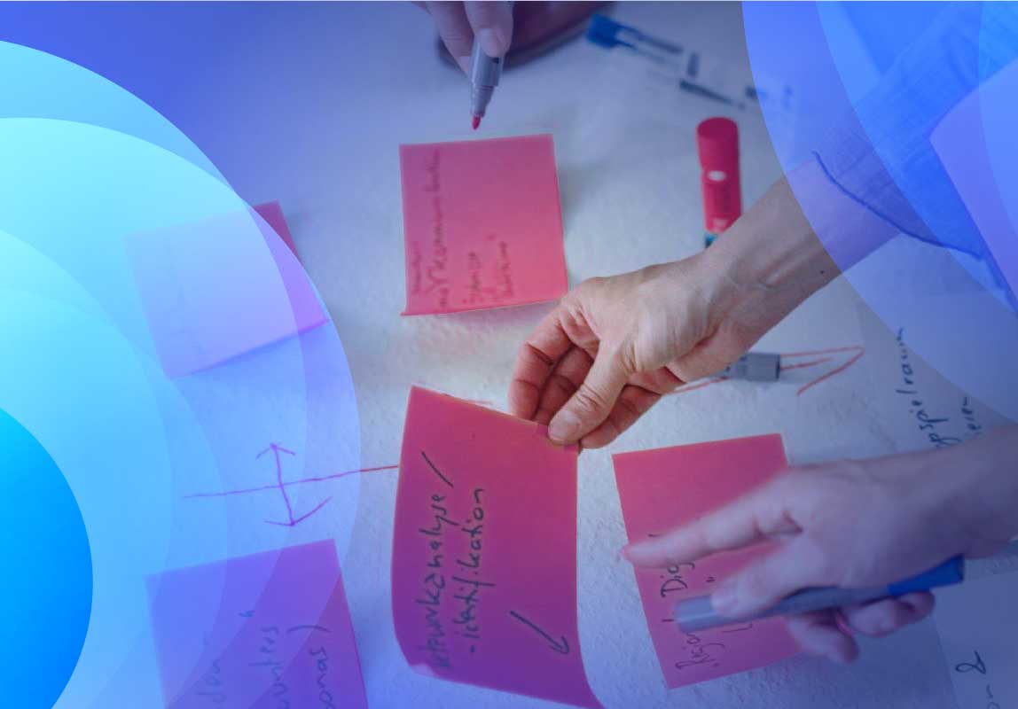 Two people brainstorming using sticky notes